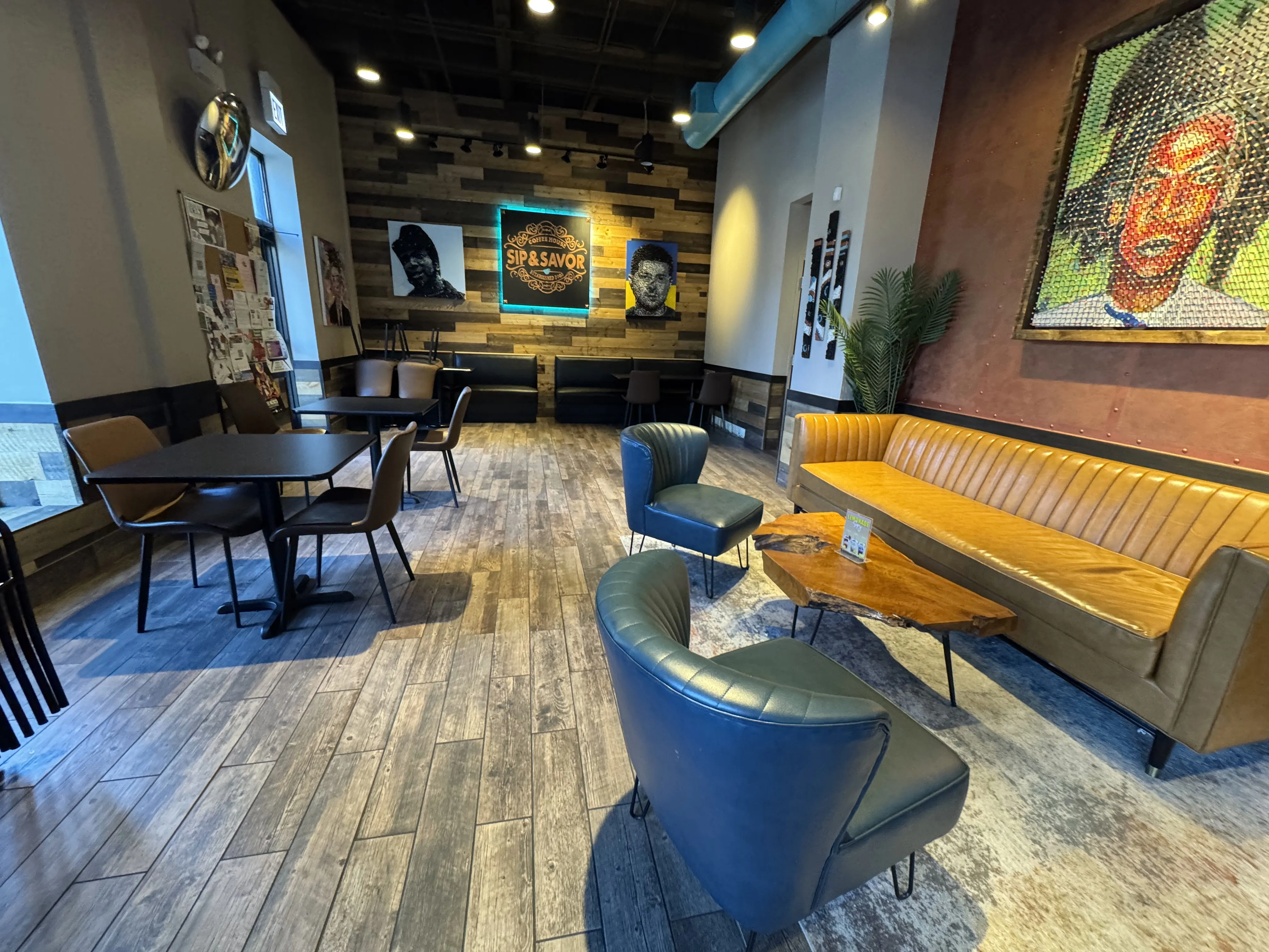 Cafe back, showing booth seating and couches around a natural-wood coffee table