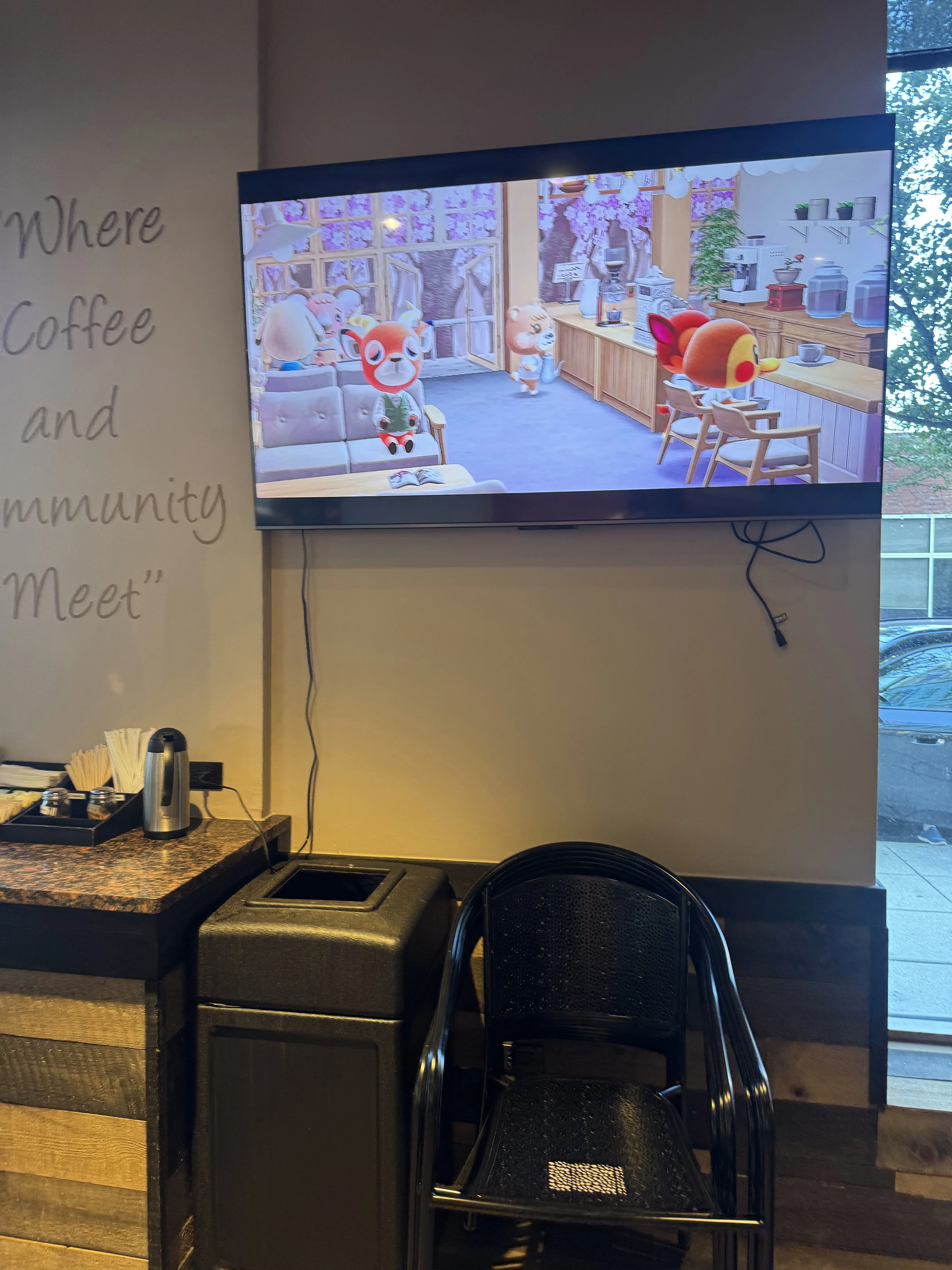 wall-mounted tv with some animal crossing visuals playing