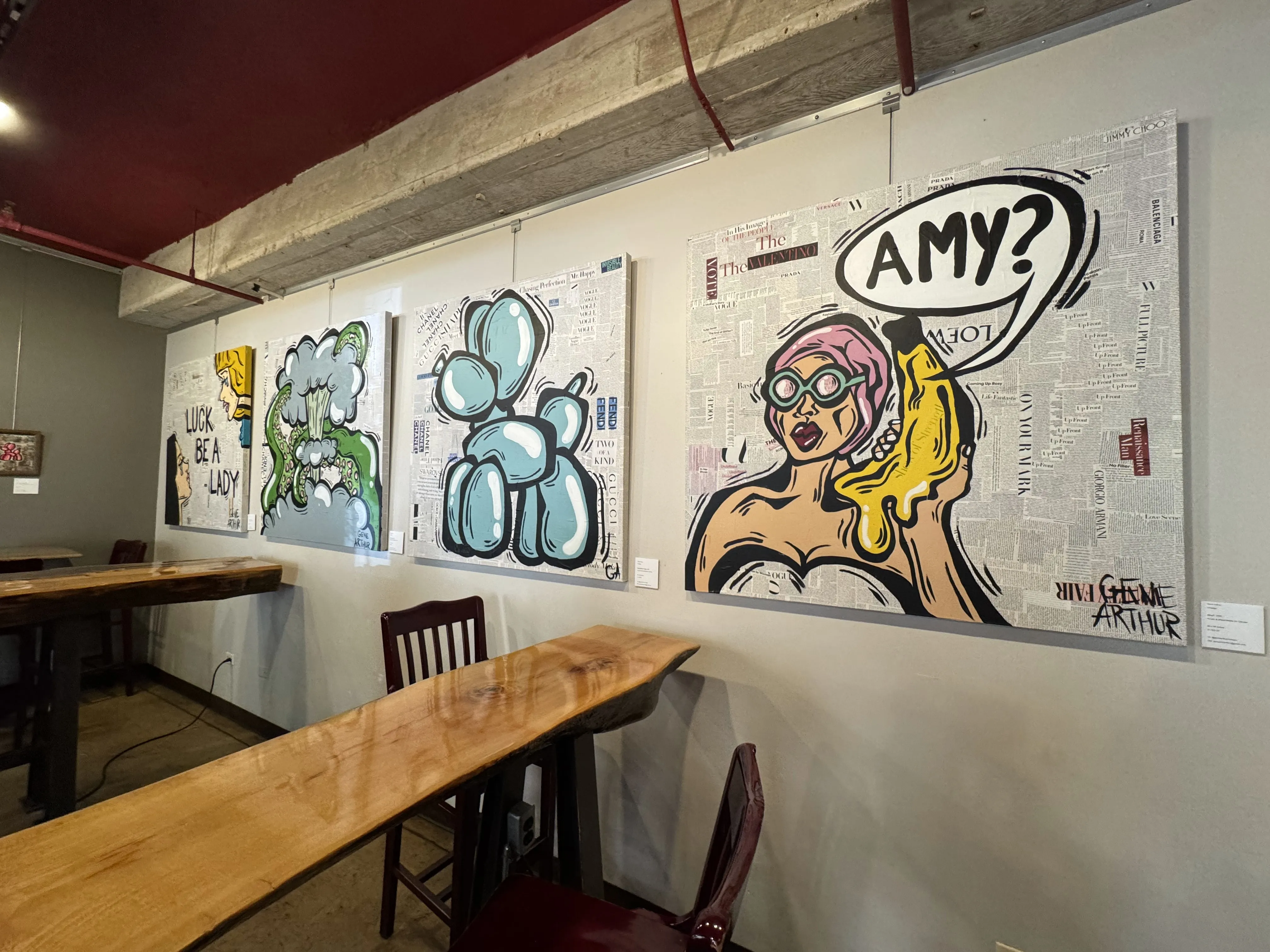 4 art canvases depicting 2 women, a tentacle explosion, a balloon animal, and a comic-style woman holding a banana