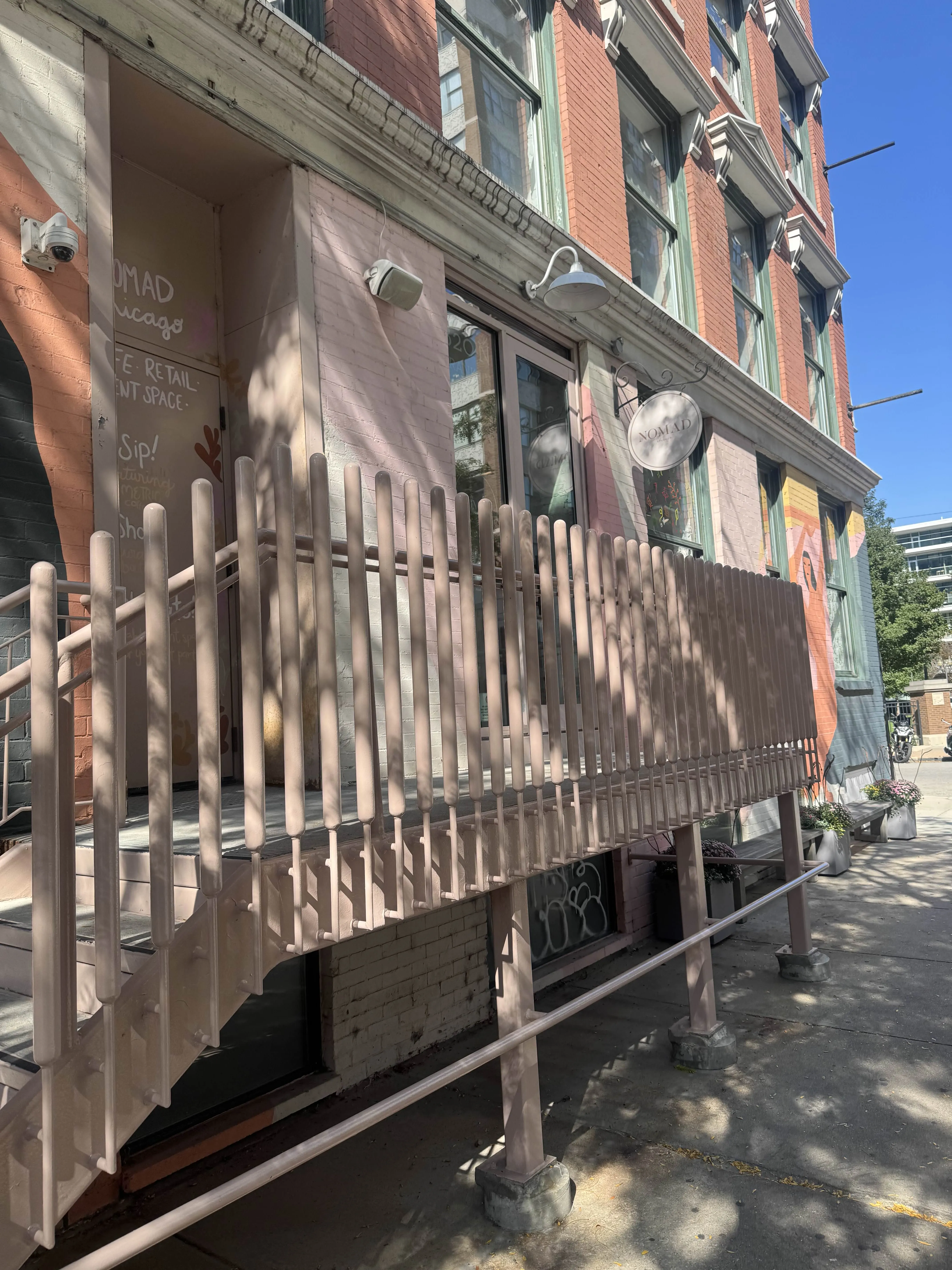 Sidewalk lead-up to the cafe. The cafe is elevated at a 2nd level, after scaling some pink painted stairs