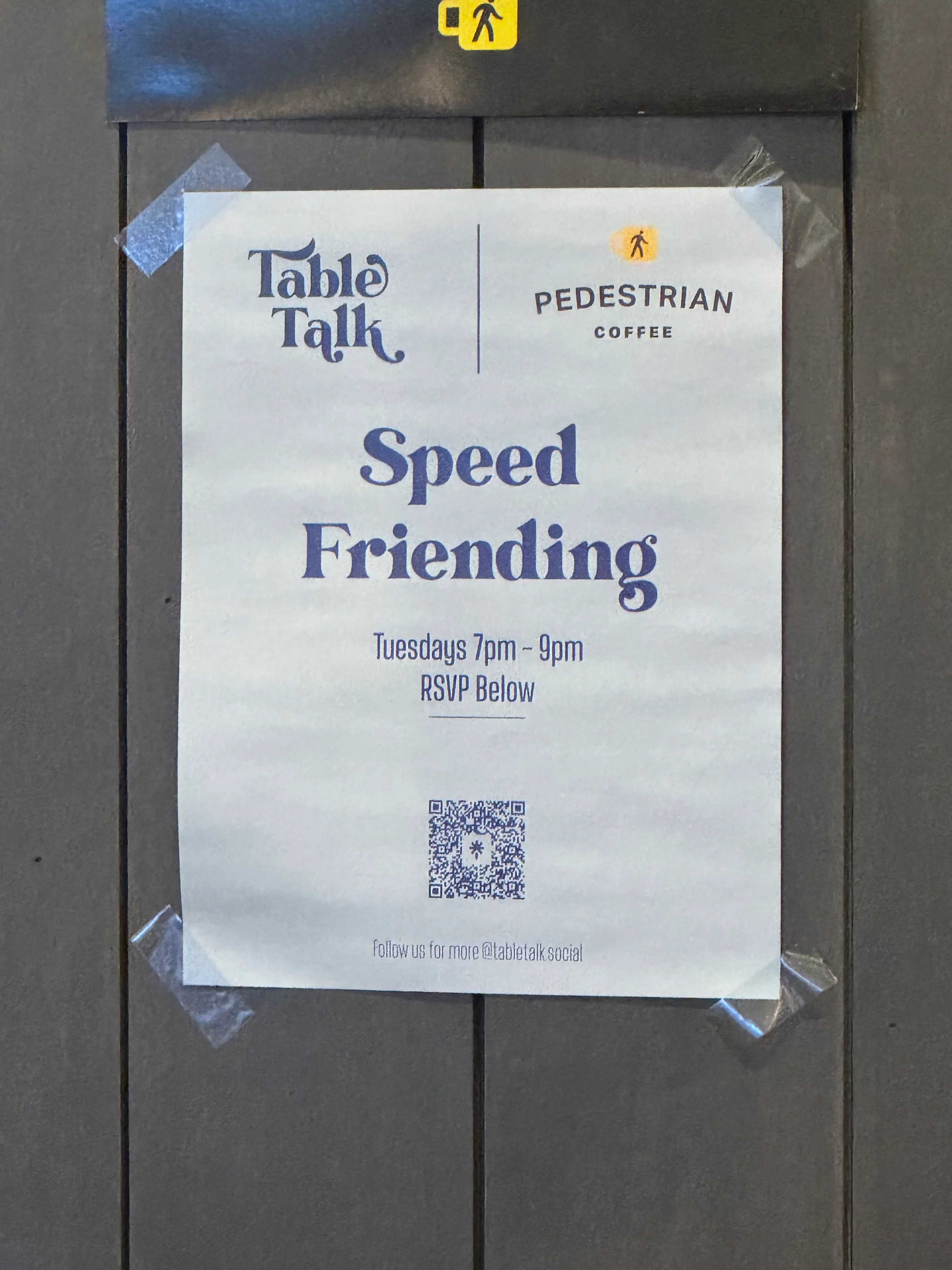 Blue poster taped to the wall, reading: "Table Talk" "Speed Friending" with time and a QR code