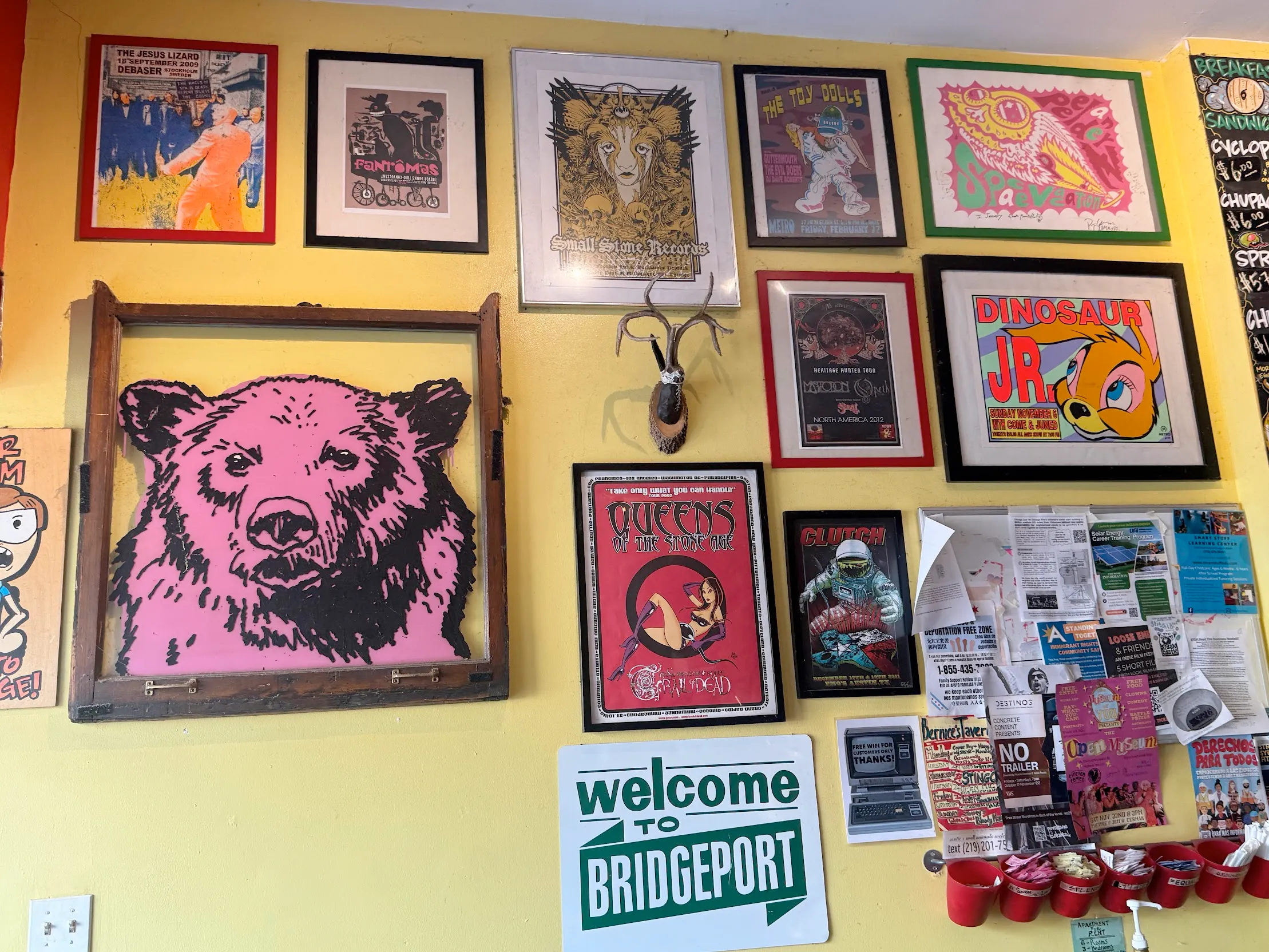 Wall covered in framed posters, predominantly of animals in various graphic and cartoony styles