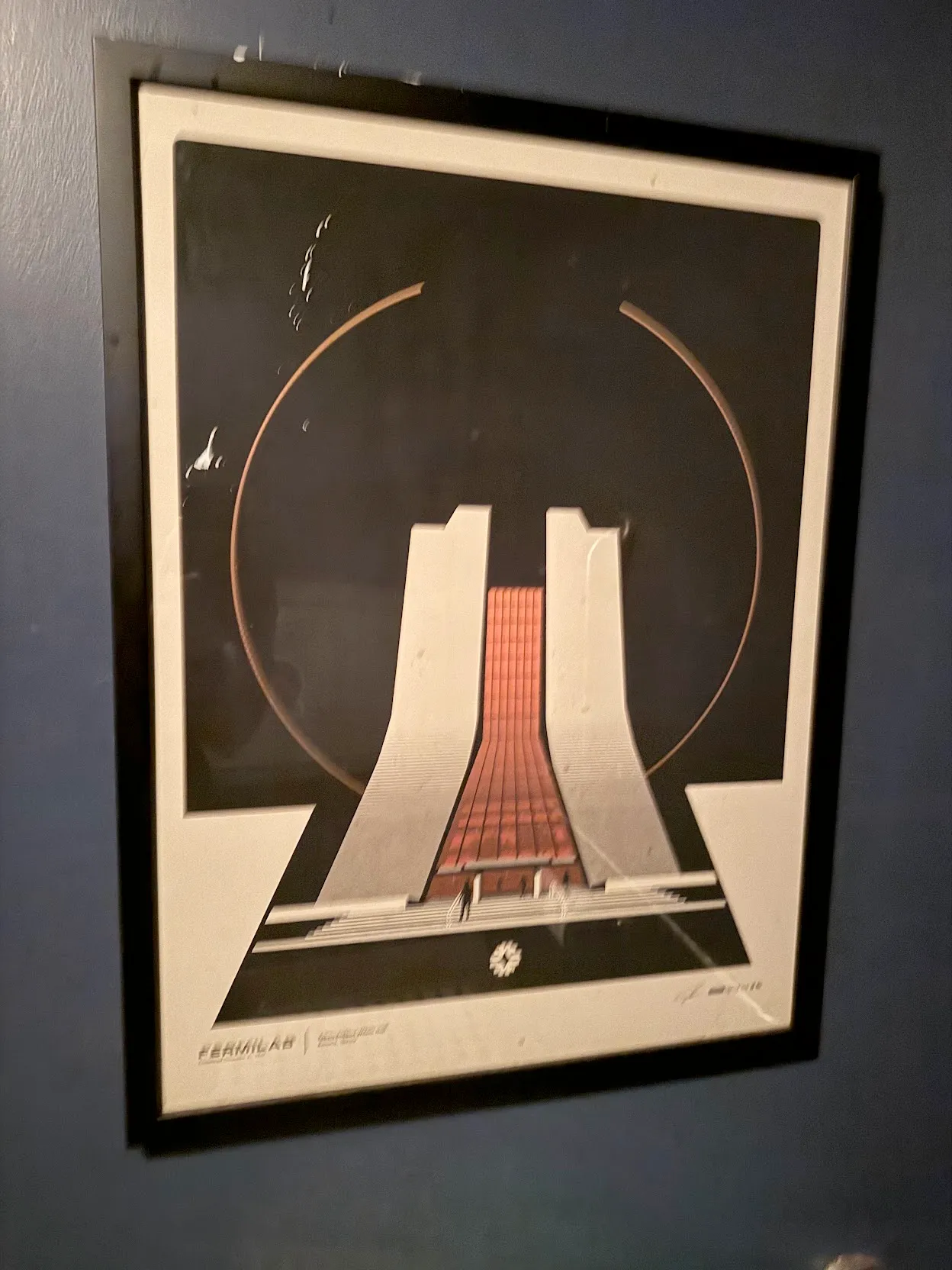 Slightly blurry photo of a fermilab graphic poster in one of the restrooms