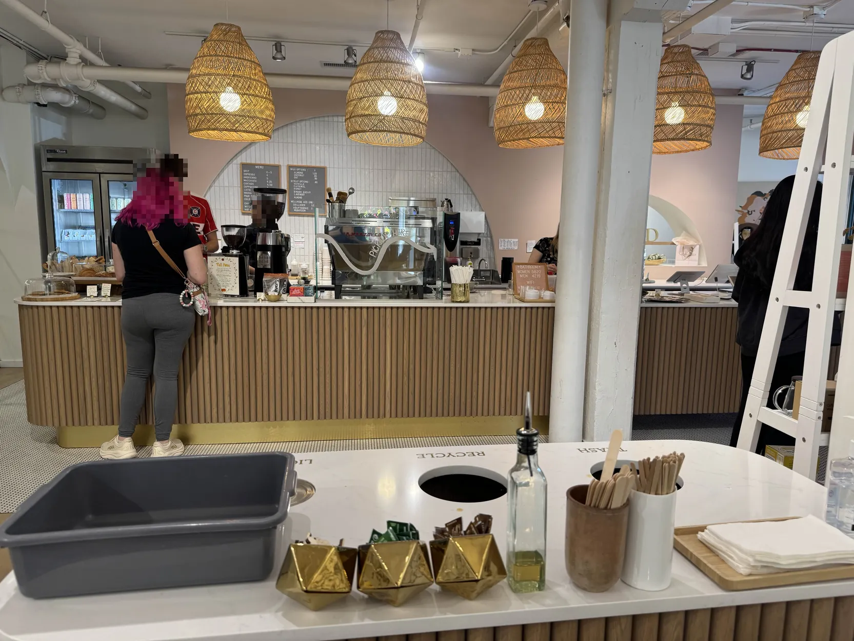 Decent shot of the coffee bar from behind the syrup-stirrer stand.