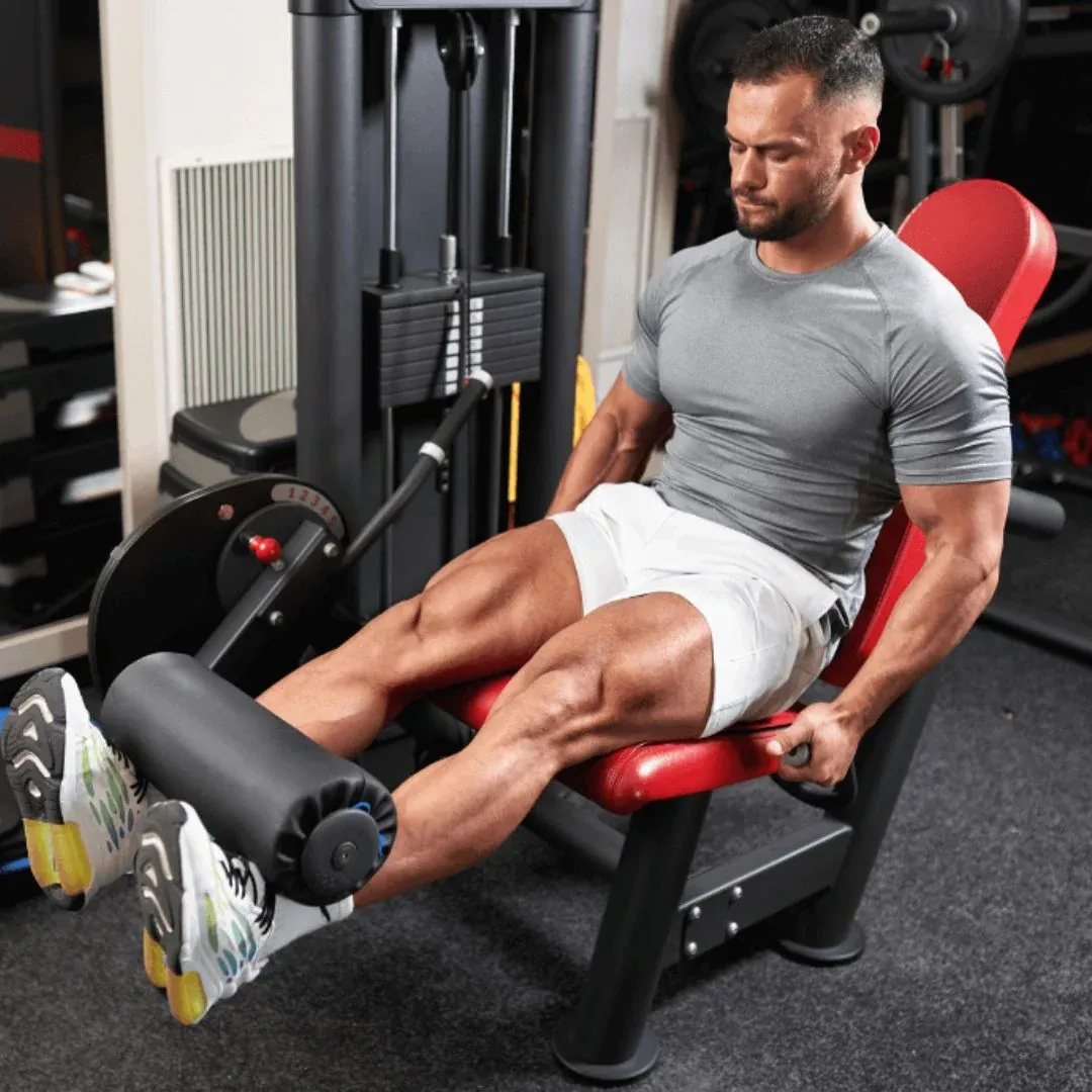 A man performing leg extensions on a machine