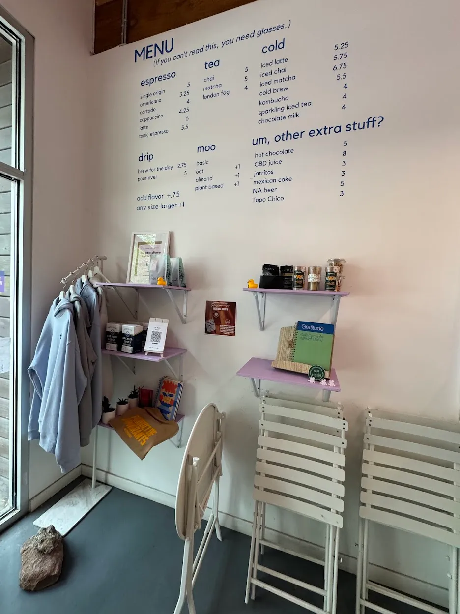 Front of cafe, showing menu, merch, and the now-disused patio furniture